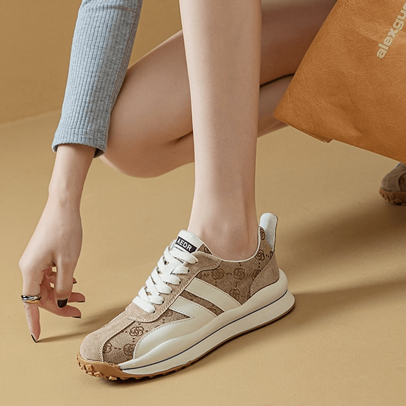 Stylish printed lace-up ankle sneakers with genuine leather design on model's foot, showcasing comfort and fashion.