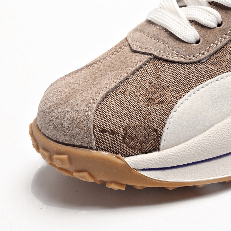 Close-up of Cozy Genuine Leather Lace-up Ankle Flat Sneaker with print and rubber sole, showcasing detailed stitching and texture.