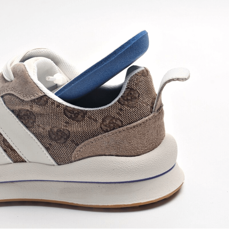 Cozy leather lace-up ankle sneakers with print, featuring a comfortable blue insole, side view close-up.