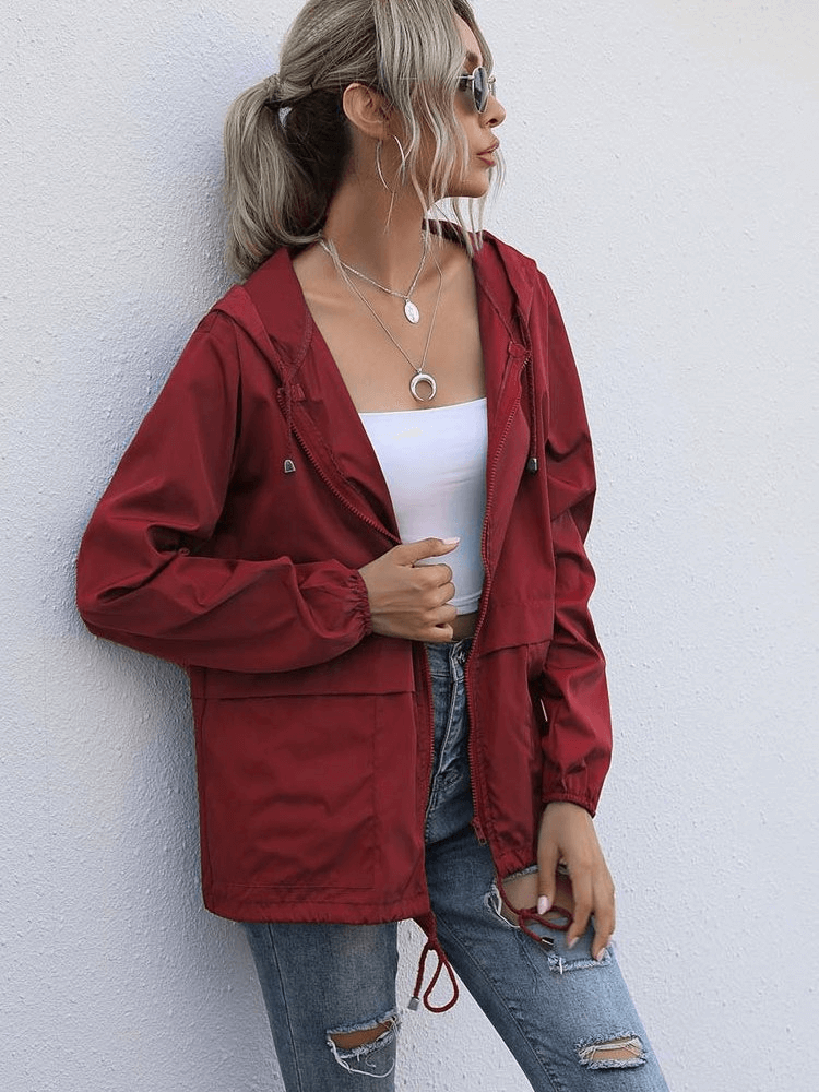 Lightweight waterproof women's red windbreaker jacket with hood and V-neck, perfect for sports and casual wear.