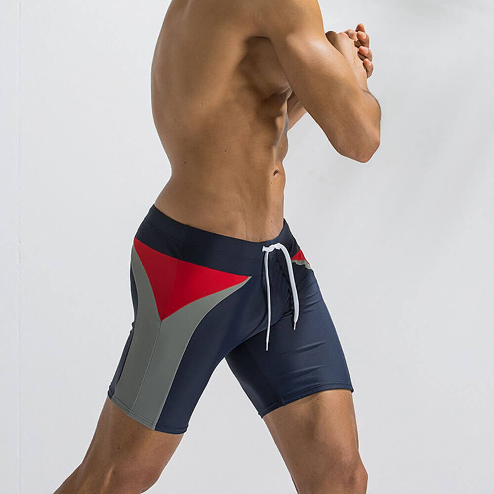 Men's long swimming trunks with patchwork design and drawstring closure in navy, perfect for beach and swim activities.