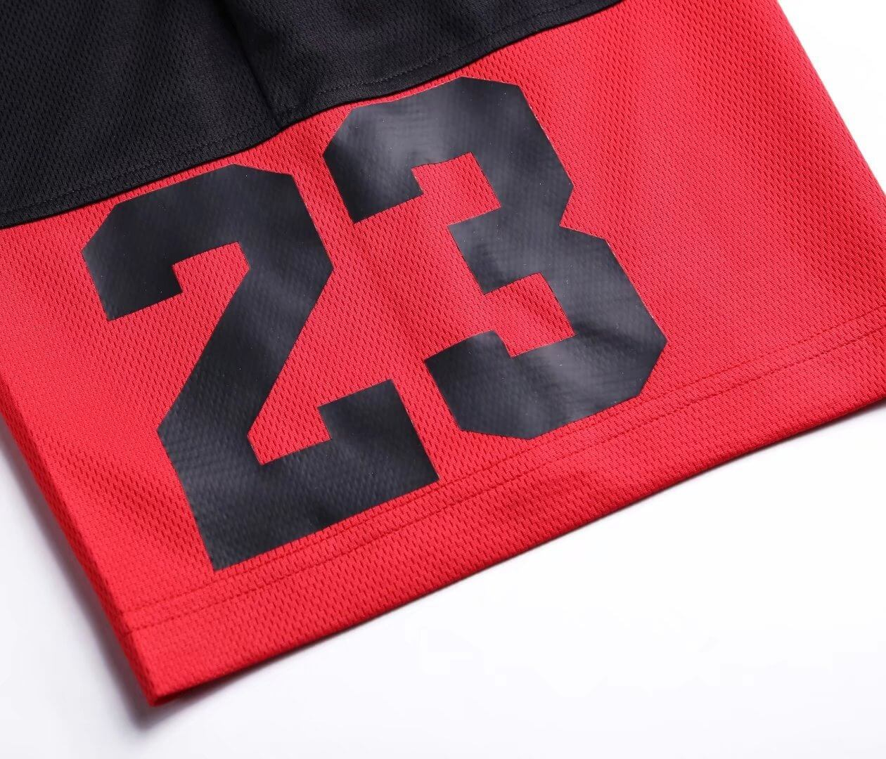 Close-up of red and black basketball shorts with number 23, highlighting stylish design and breathable fabric for optimal performance.