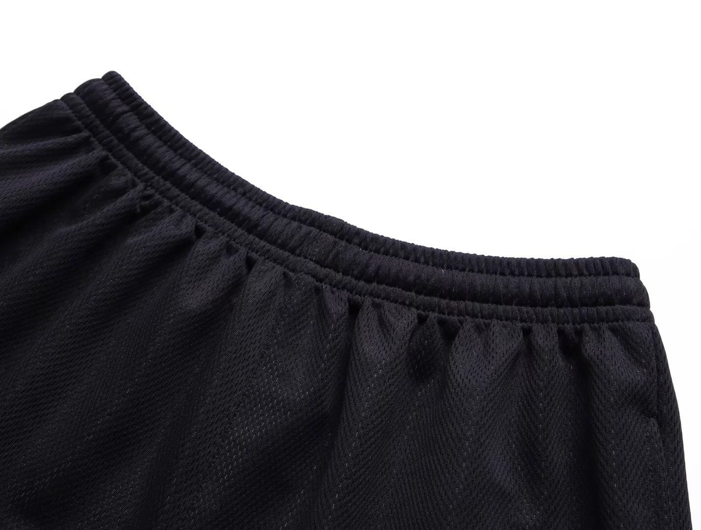 Close-up of black loose basketball shorts for men, featuring a comfortable elastic waistband and breathable fabric detail.