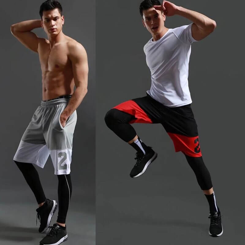 Men wearing loose basketball shorts, one in grey and white, the other in black and red, showcasing comfort and style with sporty poses.