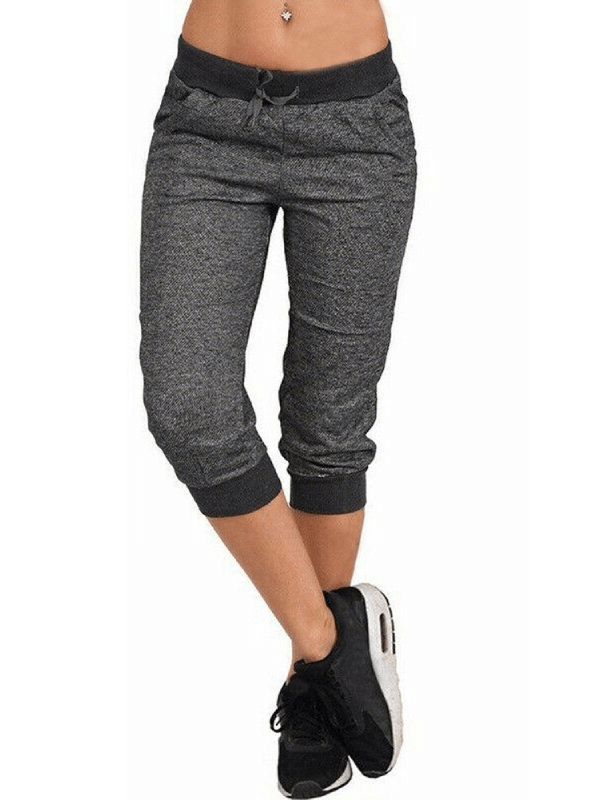 Loose cropped women's joggers with pockets, breathable cotton blend, drawstring fit, perfect for casual wear, model showcasing joggers.