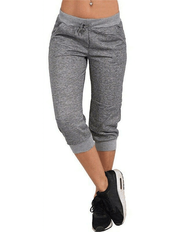 Woman wearing loose cropped joggers with pockets, showcasing casual style and comfort for everyday wear.