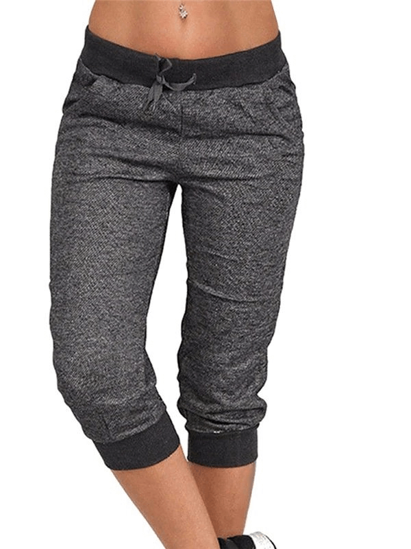 Loose cropped women's joggers with pockets, featuring a drawstring closure and casual style, perfect for everyday comfort.