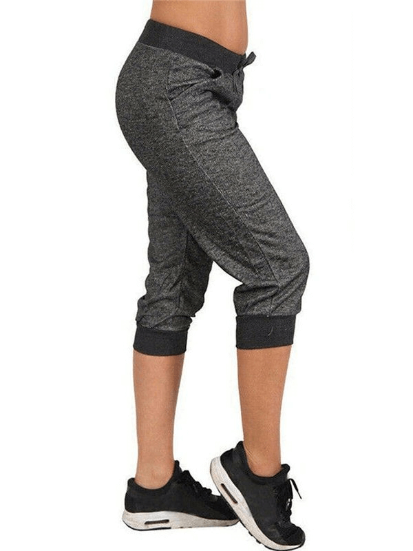 Alt Tag: Comfortable loose cropped women's joggers with pockets in grey featuring drawstring closure, perfect for casual wear.