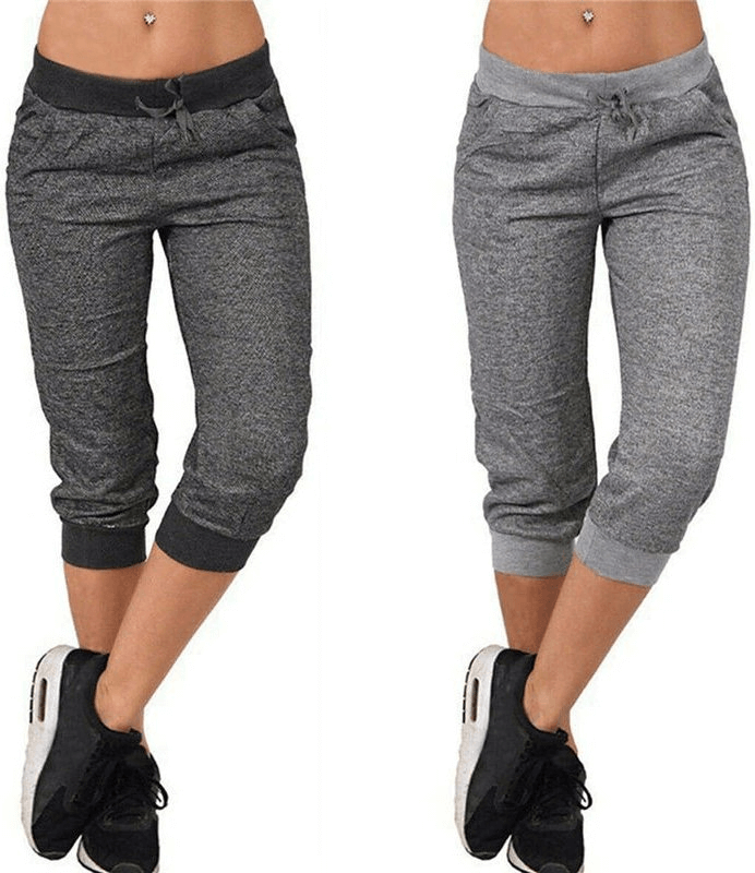 Loose cropped women's joggers with pockets in dark and light grey, featuring drawstring closure and casual fit, perfect for everyday wear.