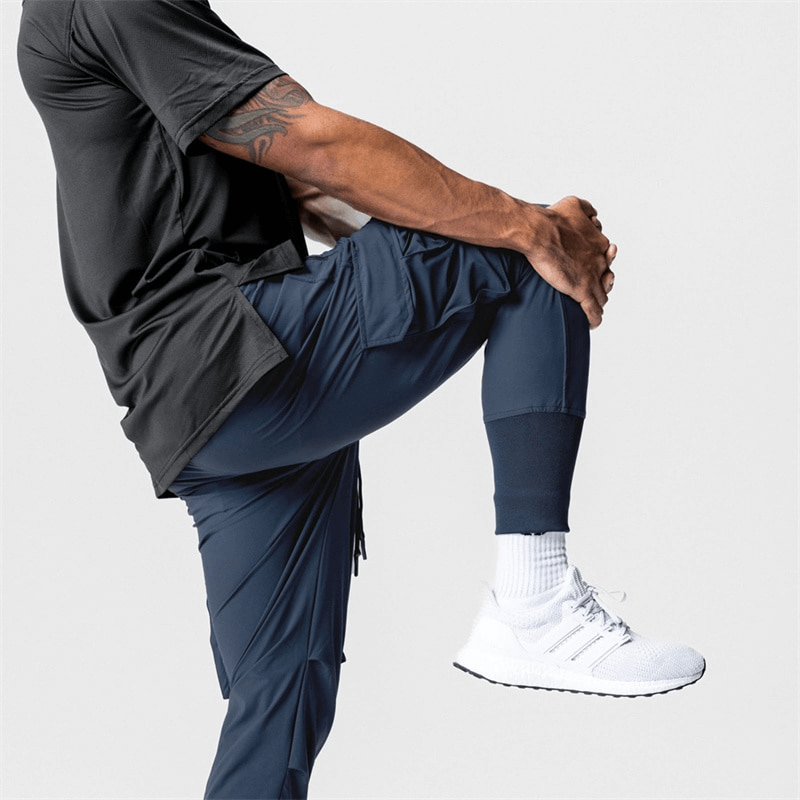 Man stretching in Loose Slim Elastic Joggers Pants with wide cuffs, perfect for workouts. Shop breathable polyester menswear - SF1141.