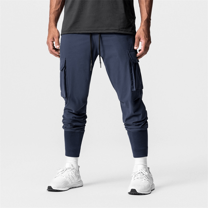 Men's loose slim elastic jogger pants with wide cuffs in navy, ideal for running and workouts. Comfortable and stylish athletic wear.