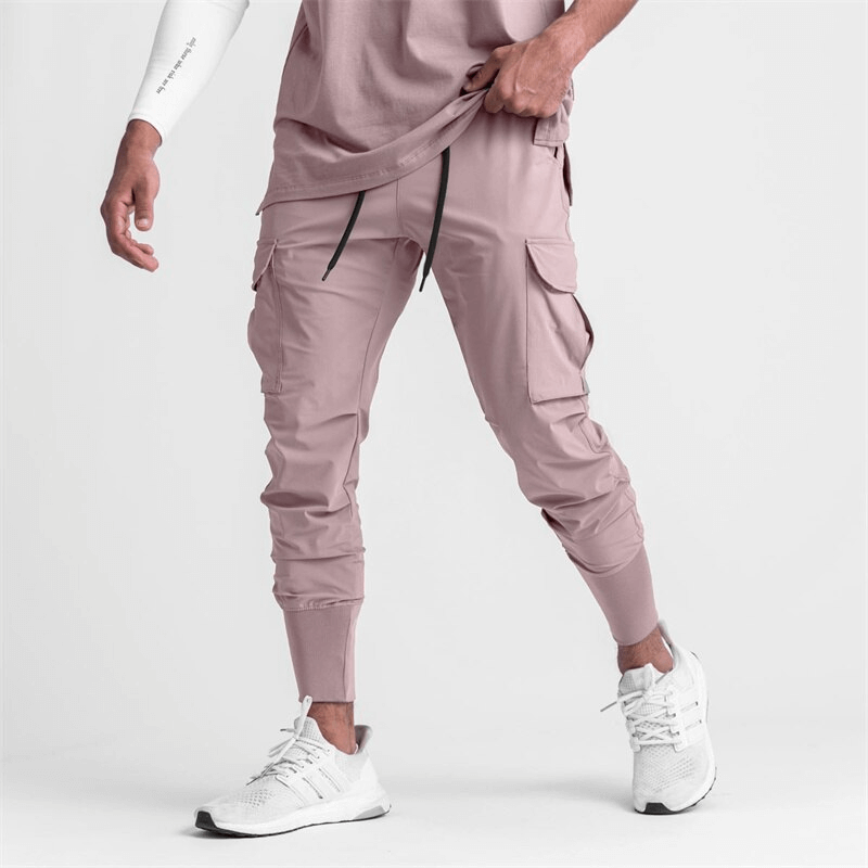 Man wearing loose slim elastic joggers with wide cuffs, perfect for workouts. Stylish and comfortable men's exercise pants.