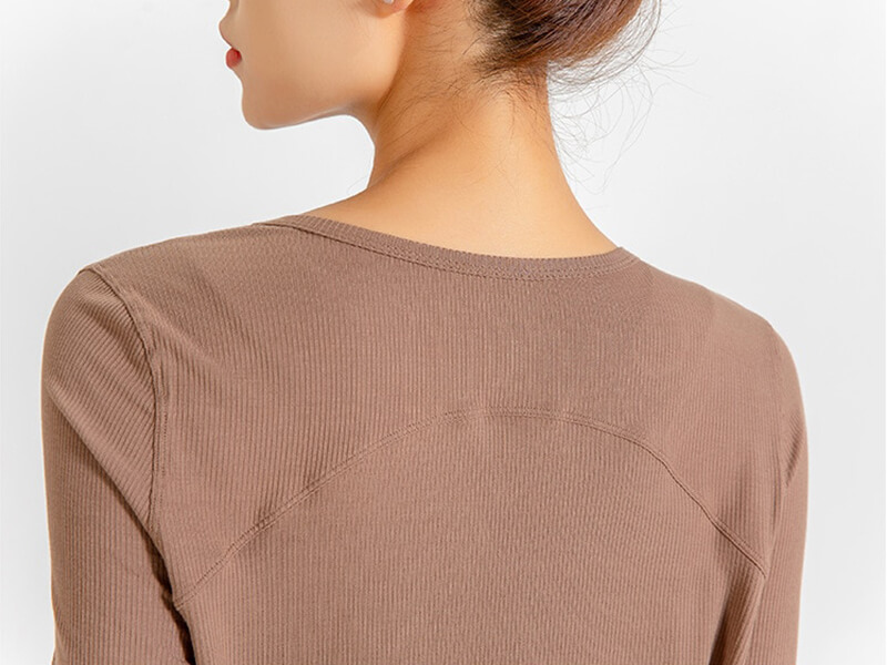 Back view of loose V-neck top for women in natural color, showcasing ribbed texture and stylish design for yoga and running.