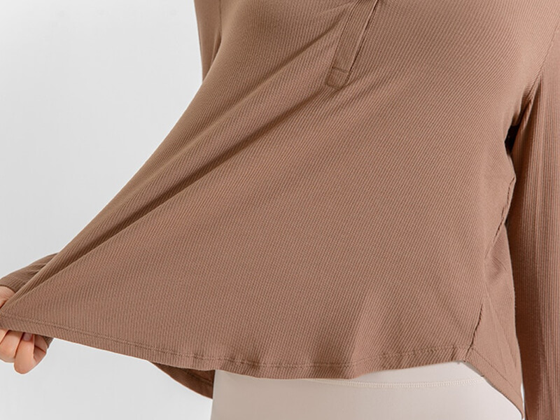 Loose V-neck top in natural color, featuring quick dry material and ribbons, perfect for yoga or running. Comfortable and stylish fit.