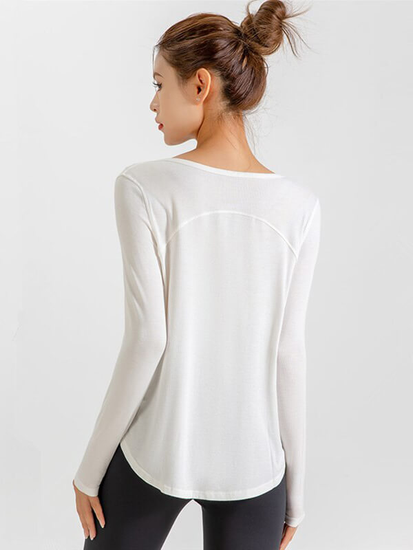 Back view of woman wearing white loose V-neck quick dry running top, perfect for yoga.