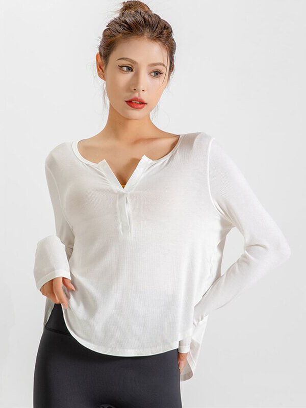 Woman wearing loose white V-neck top, quick-dry, perfect for yoga or running, with ribbon details and natural color.