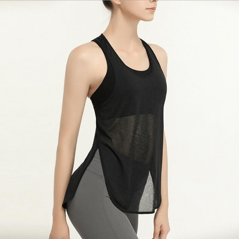 Woman wearing a loose, breathable black gym tank top, perfect for running and sports activities.