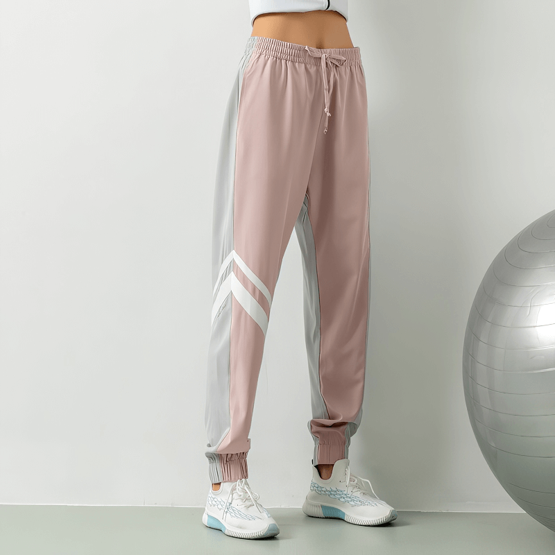 Loose women's jogger pants with thin stripe, SF1249, for running. Ankle length, mesh patchwork, drawstring closure, polyester-spandex blend.