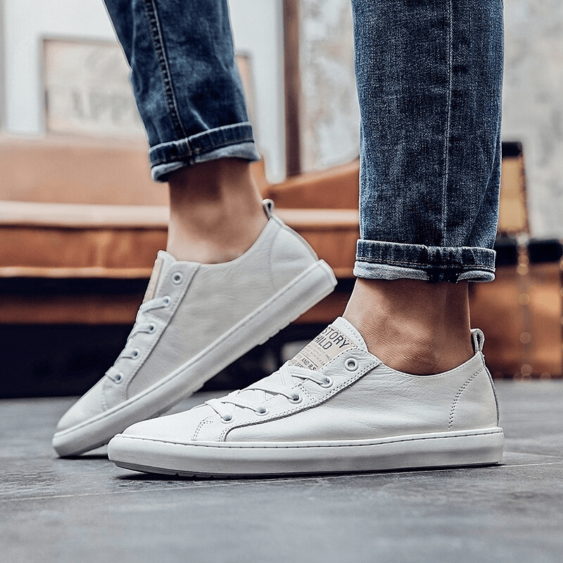 Stylish white leather sneakers with breathable design and rubber sole, perfect for casual and comfortable wear.