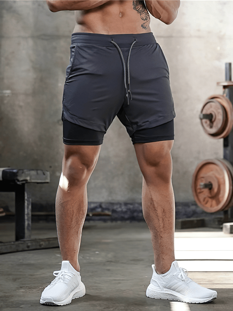 Men's double-deck running shorts with pockets, perfect for gym workouts and jogging, featuring quick-dry fabric and sleek black design.