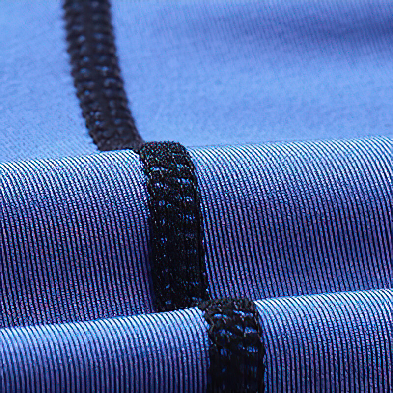 Close-up of blue male workout compression tights showcasing elastic patchwork stitching for sports flexibility.