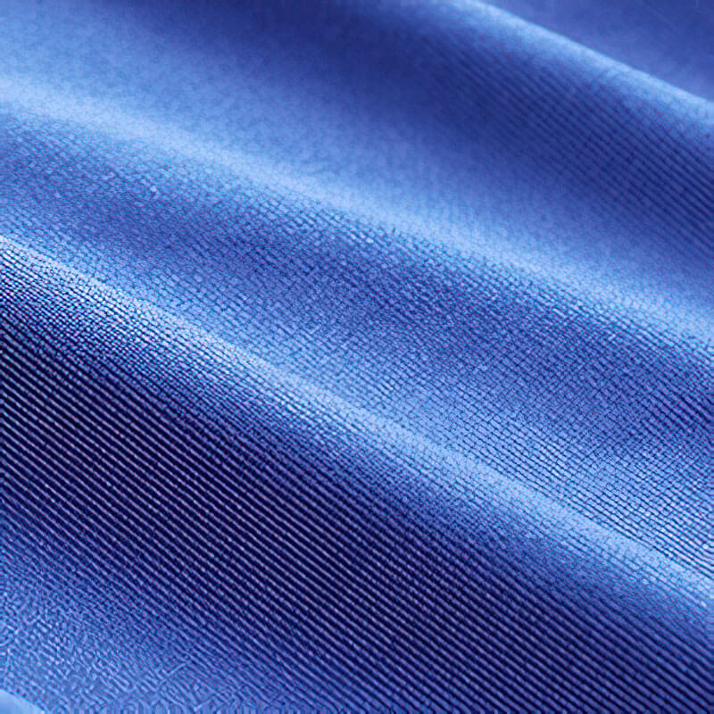 Close-up of blue polyester-spandex fabric showcasing texture and flexibility for compression tights.