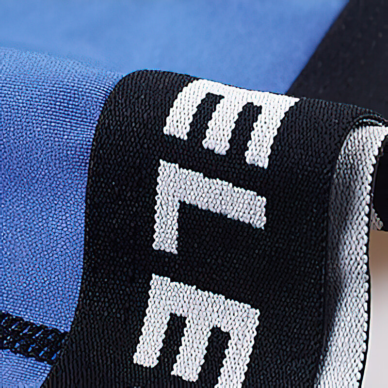 Close-up of blue male elastic short compression tights with black and white waistband, perfect for workouts and athletic activities.