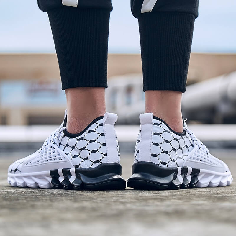 Person wearing male mesh running shoes, SF0762, with gingham pattern, breathable material, and cushioned soles, outdoors.