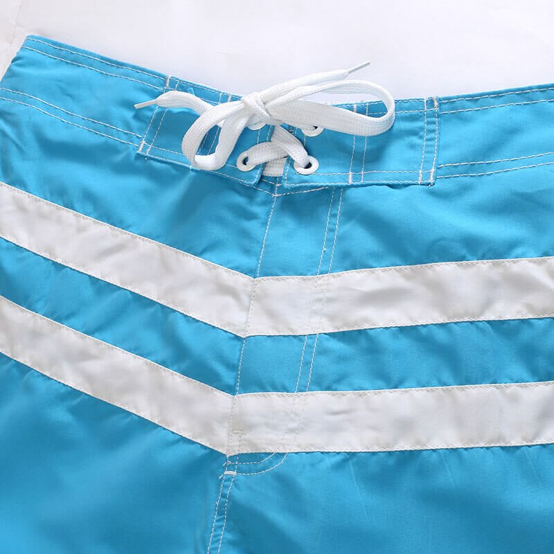 Blue striped quick dry boardshorts for surfing, breathable polyester with white drawstring, ideal for beach activities.