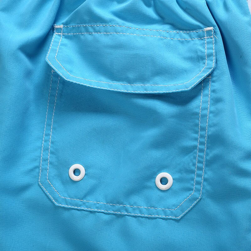 Close-up of blue quick dry boardshorts pocket with eyelets.