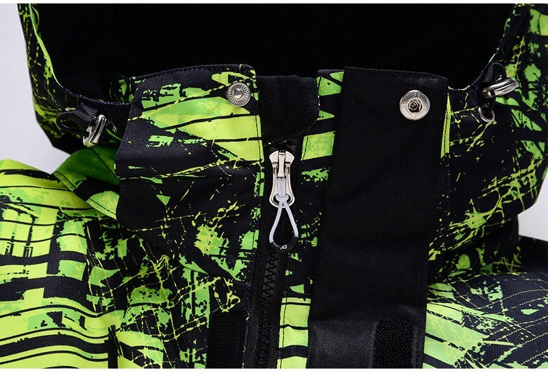 Close-up of men's windproof waterproof ski jacket with green and black print, featuring durable zipper and adjustable hood.
