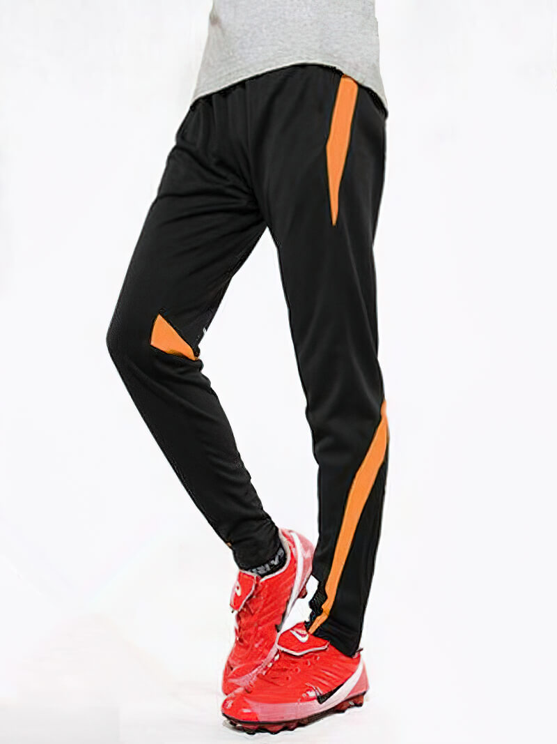 Male sports elastic waist trousers for workout, black with orange stripe, worn with red sneakers; perfect for running or gym activities.