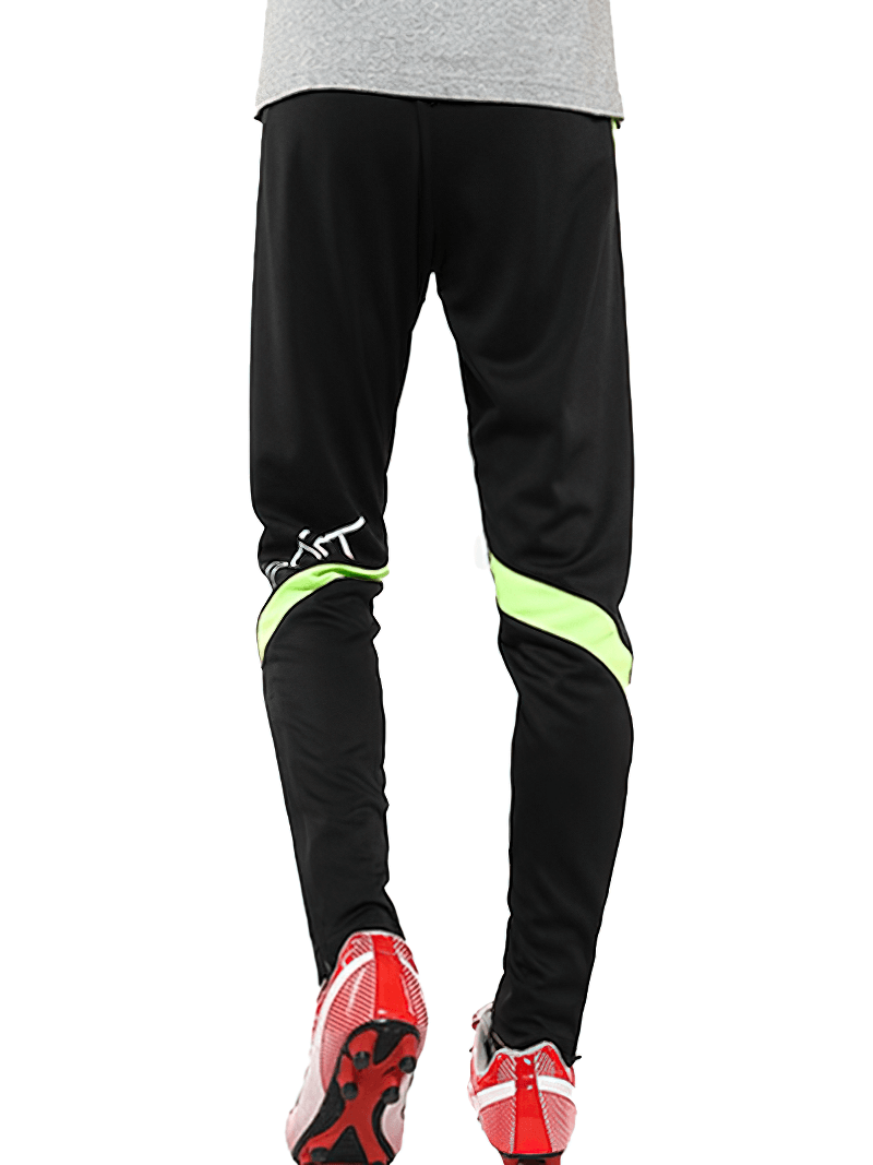 Man wearing black sports trousers with elastic waist, perfect for workouts and running, showcasing comfort and style.