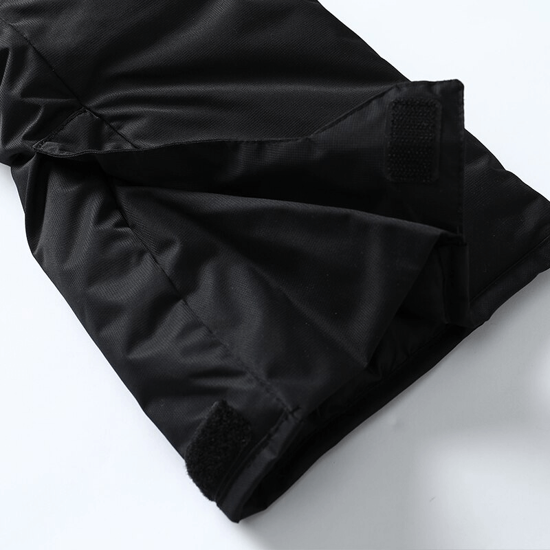 Close-up of black male snow pants with adjustable straps, showcasing zipper and waterproof fabric for winter activities.