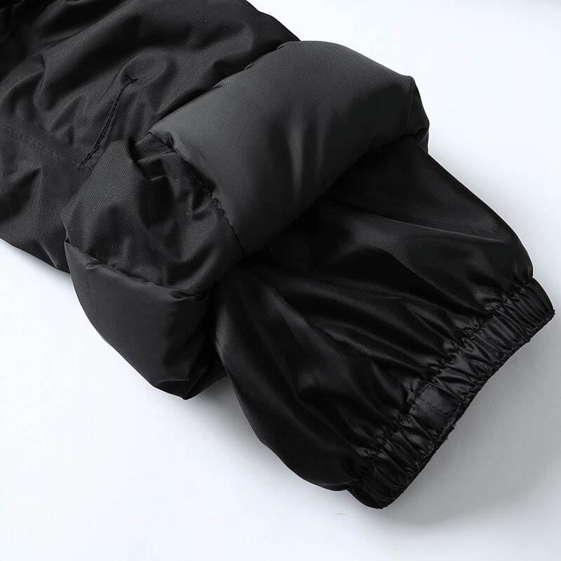 Close-up of black male snow pants with elastic cuff detailing, designed for warmth and flexibility in winter outdoor activities.