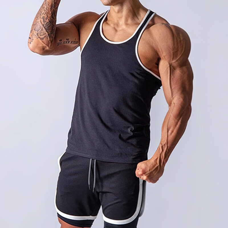 Muscular man wearing a black cotton tank top and shorts for workout, showcasing athletic build and sporty style.