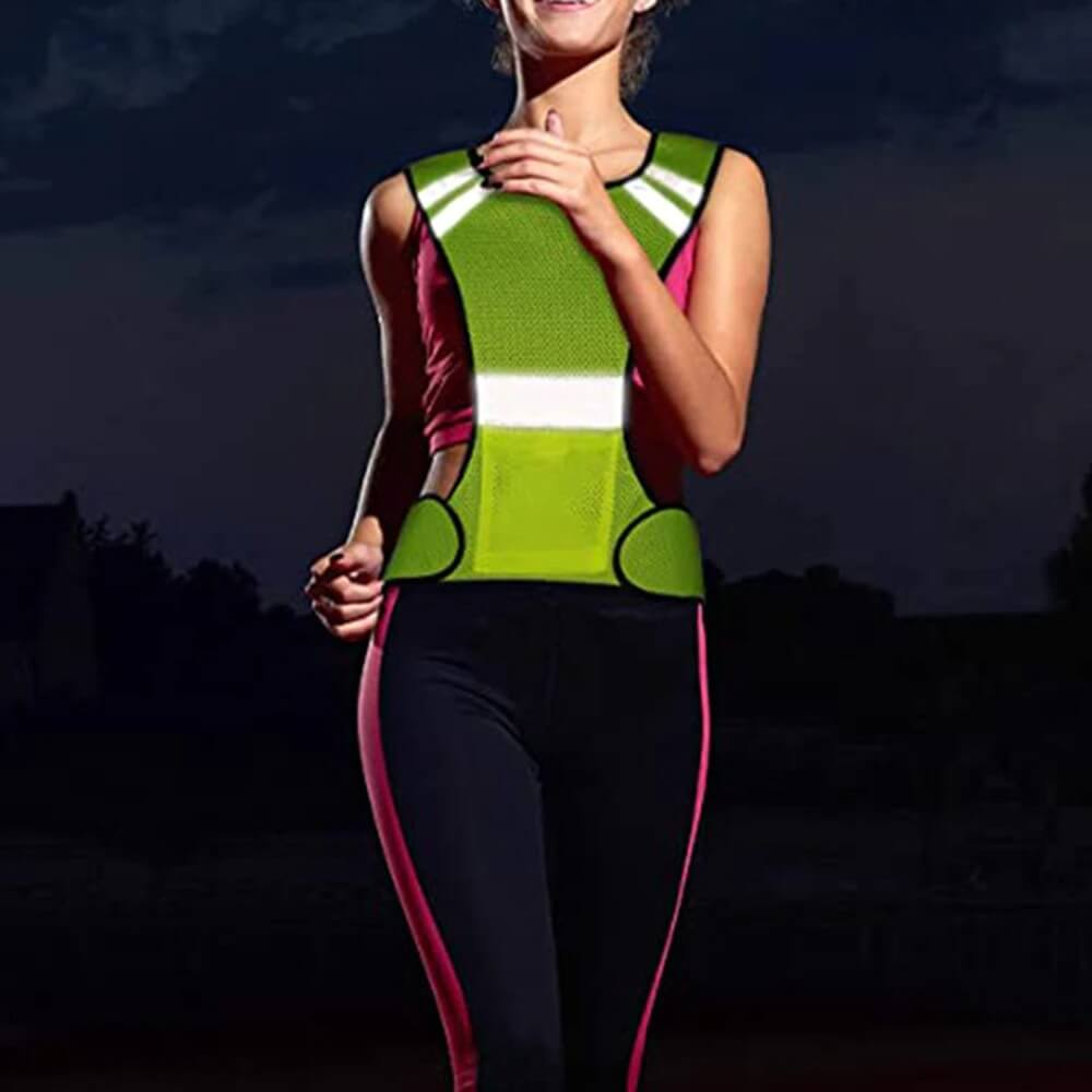 Running at night in a reflective vest for high visibility, featuring breathable polyester and gore-tex fabric in vibrant green.