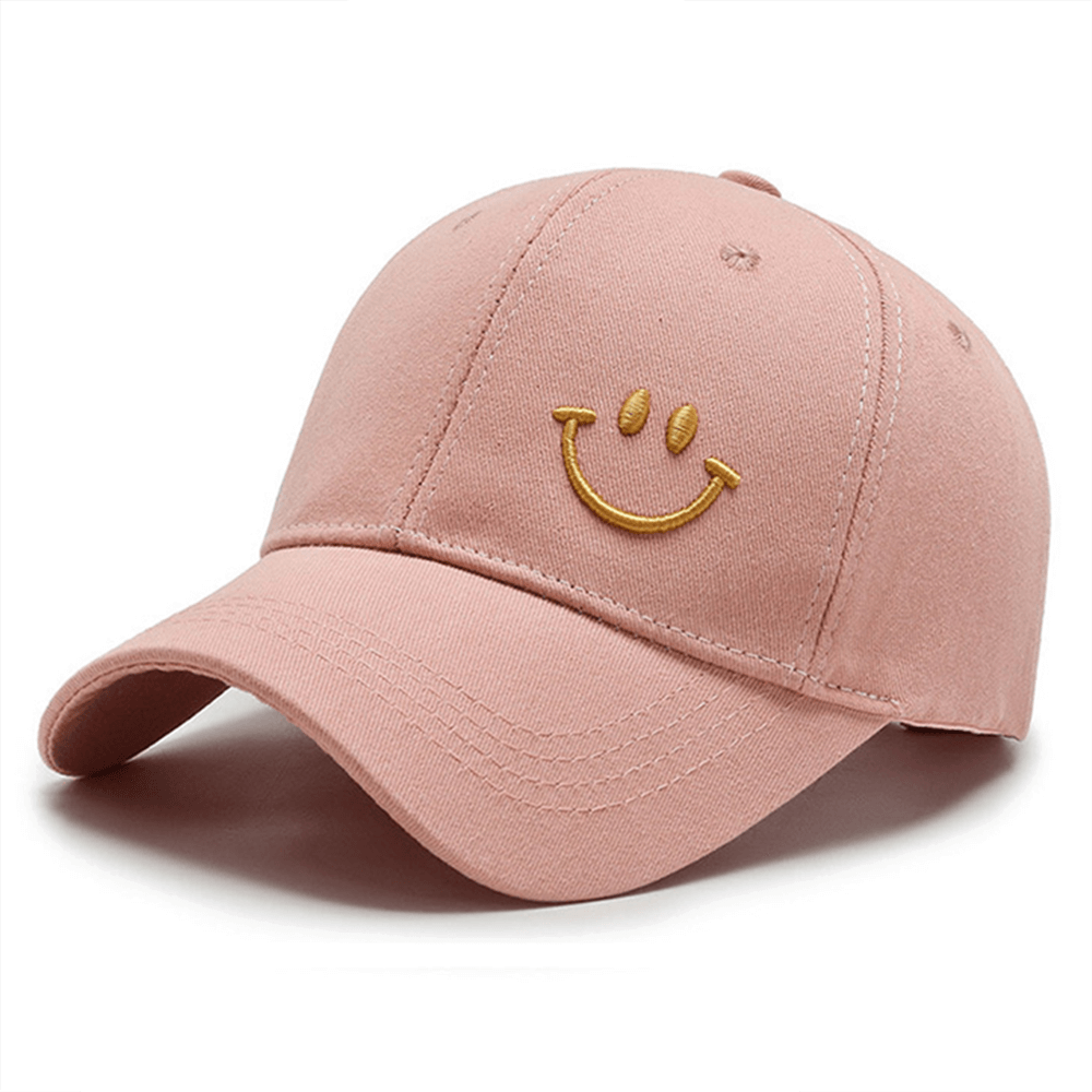 Unisex pink baseball cap with smiley face embroidery, UPF 50+ sun protection, adjustable strap, made from cotton.