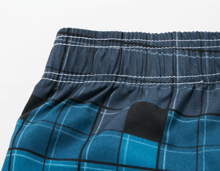 Close-up of men's quick dry swimming shorts in blue plaid with elastic waistband - SF0860