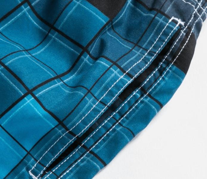 Close-up of blue plaid pattern on men's beach quick dry swimming shorts SF0860 with detailed stitching and breathable polyester fabric.