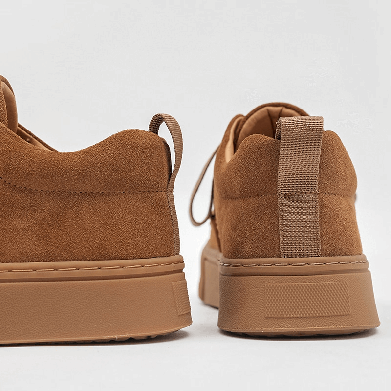 Close-up of brown leather stylish sneakers showcasing the durable rubber outsole and breathable design. Men's casual shoes SF0973.