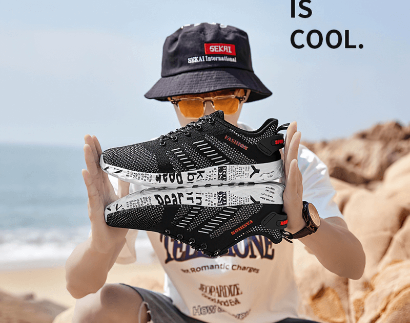 Man holding Men's Casual Lace-up Mesh Sneakers with soft outsole, featuring black design and geometric pattern, perfect for beach style.