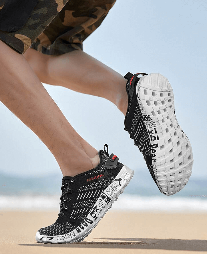 Man running on beach wearing men's casual lace-up mesh sneakers SF0805, featuring soft outsole and geometric pattern for comfort.