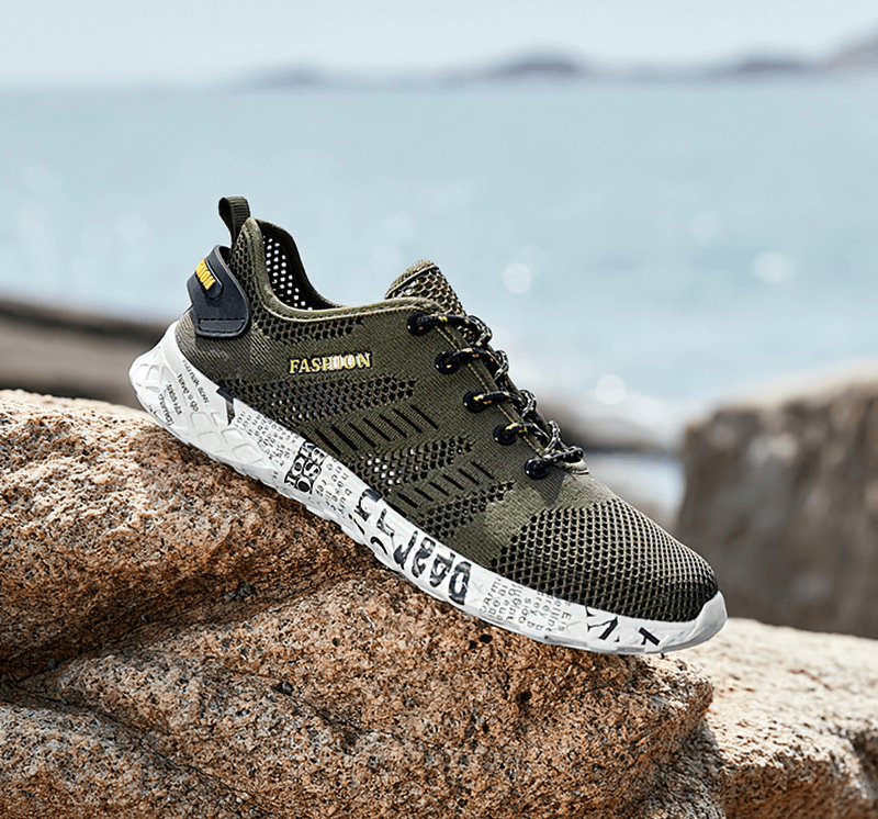 Men's casual mesh sneakers with lace-up design and soft outsole, ideal for comfort and style, displayed on rocky terrain.