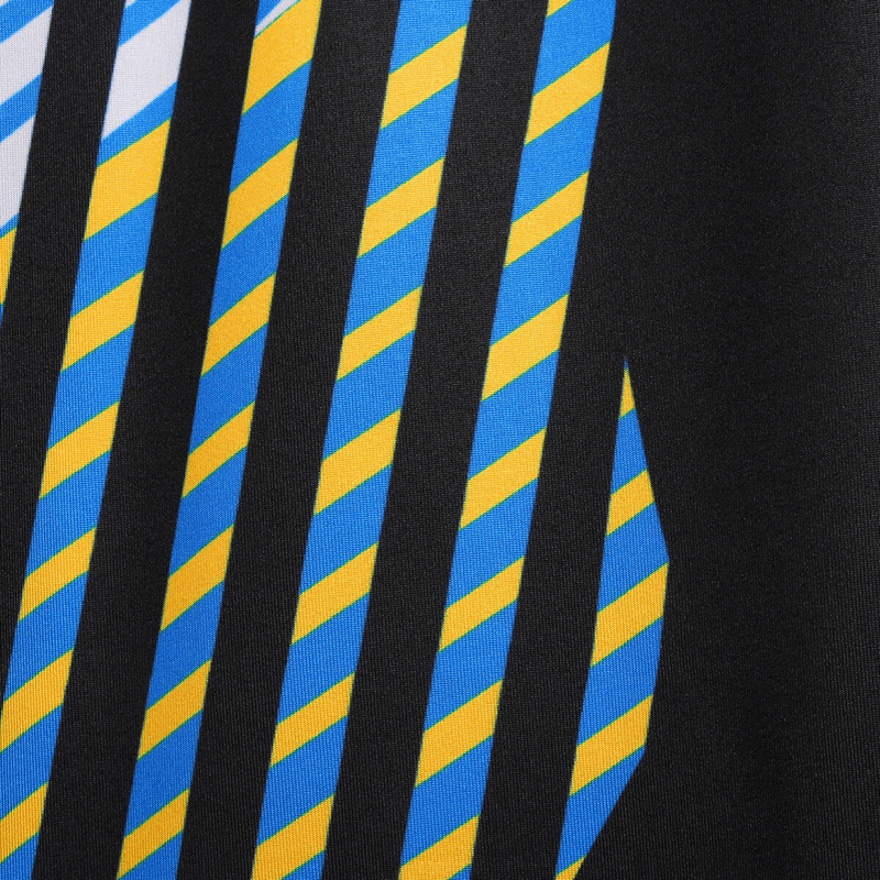 Close-up of striped fabric design in blue, yellow, and black on men's compression sports leggings for running.