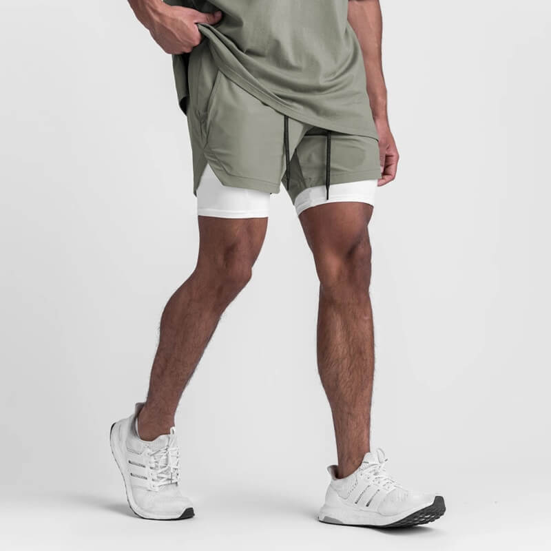Man wearing double-layer running shorts with pockets, comfortable and breathable for sports activities, in light gray and white, SF1105 model.