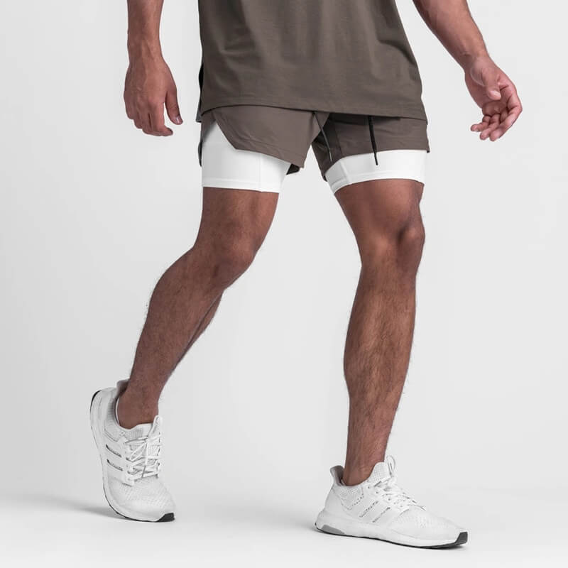 Man wearing men's double-layer sports running shorts with pockets, SF1105, showcasing stylish design and comfort for active lifestyles.