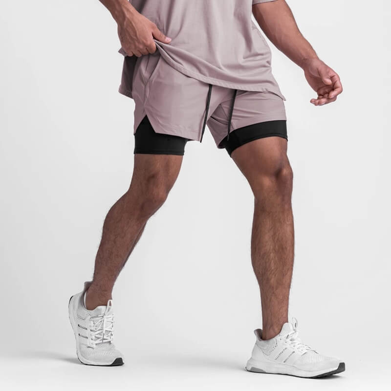 Men's double-layer sports running shorts with pockets, stylish and comfortable for active wear, shown with drawstring closure in action.