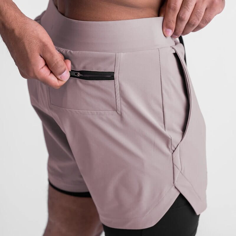 Men's double-layer sports shorts with zipper pocket for convenience, ideal for running and gym, in breathable polyester fabric.