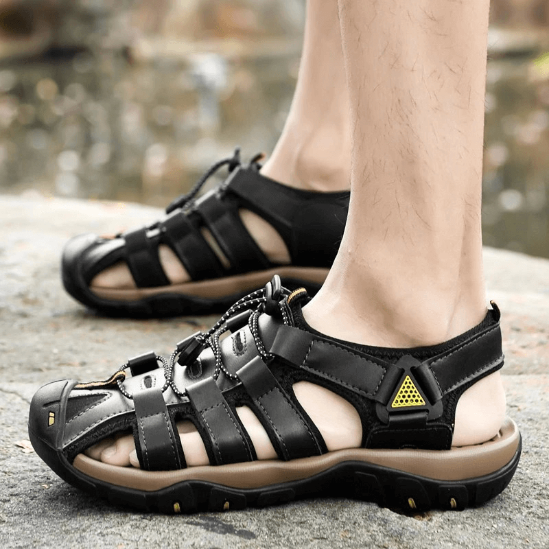 Men's genuine leather lightweight sandals with rubber outsole, perfect for outdoor beach adventures; shown in black, worn comfortably.
